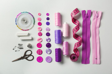 Composition with threads and sewing accessories on white background