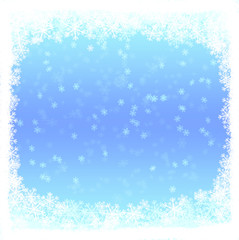 Blue light winter background with falling snowflakes