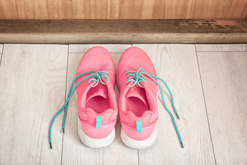 Sneakers on floor indoors. Morning routine concept