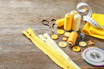 Accessories for sewing on wooden background
