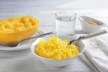 Bowl with flesh of spaghetti squash on wooden background