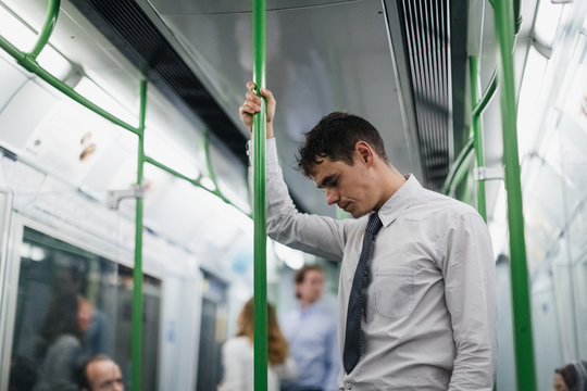 Businessman using public transports in the City