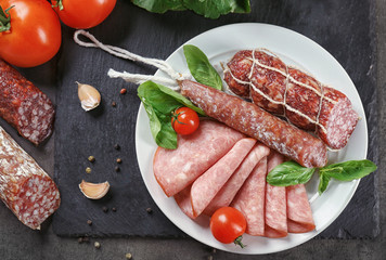 Delicious sliced sausages on plate