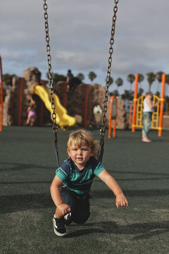 Toddler Playing on Swing Set