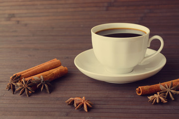Obraz na płótnie Canvas A hot Cup of coffee, cinnamon and star anise