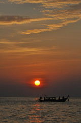 Fototapeta na wymiar Fishermen at sunset in Ko Phi Phi