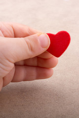 Little red color heart shape in hand