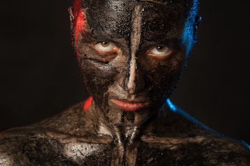 woman with black dirty smeared make up on black background