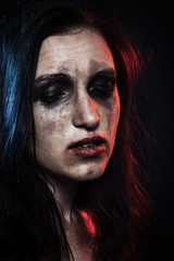 sad woman with smeared cosmetics on dark background