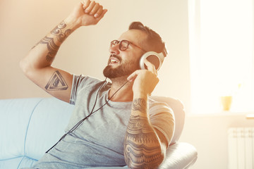 happy emotional man listening to music with headphones