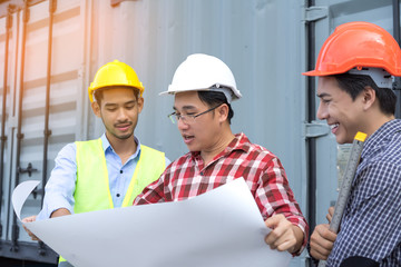 Three Engineer men with safety helmet teamwork building consult project looking paper plan in side construction with level