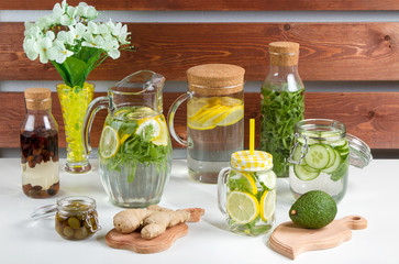 refreshing drink with lemon and seasonings in the summer morning with flowers