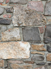 Stonework in rows with mortar in many colors