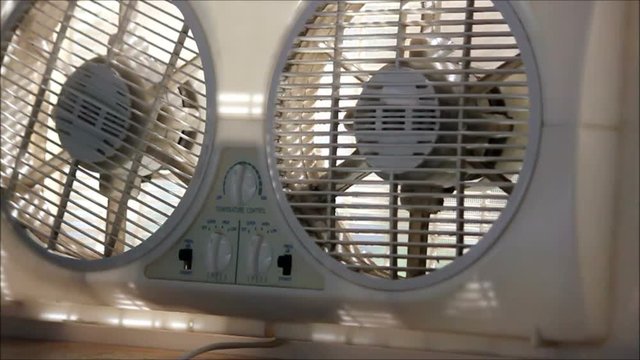 girl's hand turns fan on then off again