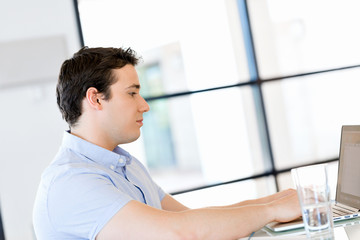 Handsome businessman working at computer