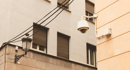 CCTV surveillance camera on a stone wall