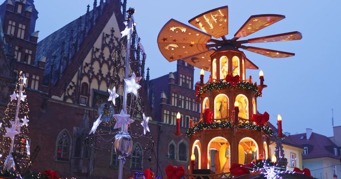 European Christmas Market Scene. 4K. Traditional pyramid birth of Christ and Decorated with lights Wroclaw (Breslau) City Hall, Advent Christmas Fair. Winter Holiday Season. Travel Europe Concept.