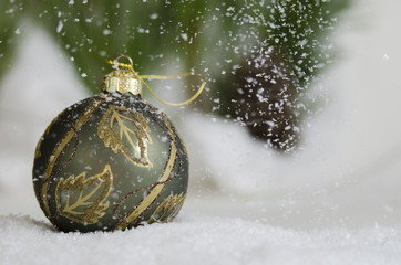 Green ornament in the snow fall