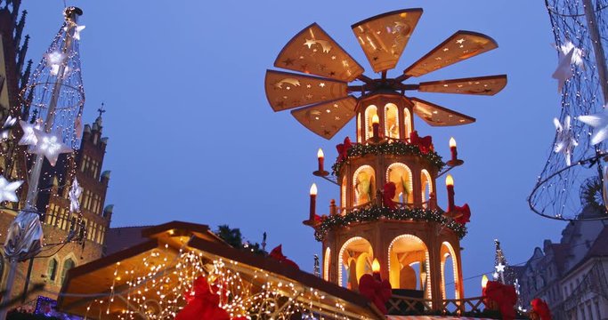 European Christmas Market Scene. 4K. Traditional pyramid birth of Christ and Decorated with lights Wroclaw (Breslau) City Hall, Advent Christmas Fair. Winter Holiday Season. Travel Europe Concept.