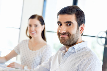 Image of two young business people in office