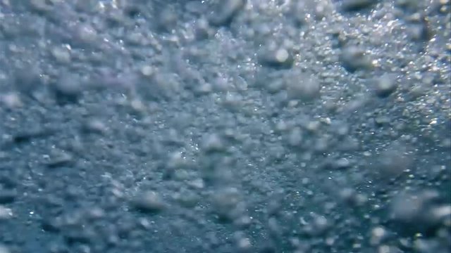 Bubbles underwater background in slow motion. Deep and blue water natural bubbles shot.