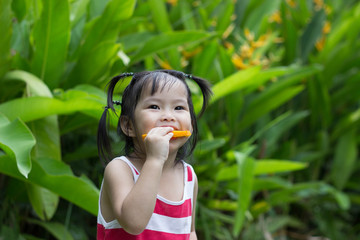 Cute child  girl  portrait eating oranges  Outdoor .