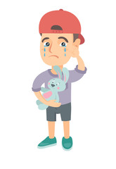 Caucasian boy in a cap crying and wiping the tears away. Little boy crying and holding toy rabbit in hand. Vector sketch cartoon illustration isolated on white background.