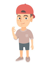 Caucasian little smiling boy in a cap showing an ok sign. Happy boy making an ok sign. Cheerful boy gesturing an ok sign. Vector sketch cartoon illustration isolated on white background.