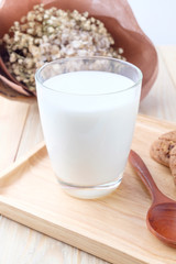 Milk in glass on wooden background