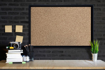 Desk space concept. Mock up Cork board, vintage camera and films on wood table workplace with...