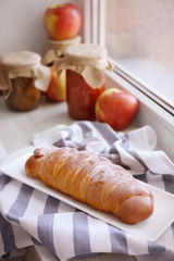 Fresh baked roll on windowsill