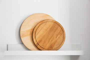 Wooden round boards on shelf in kitchen