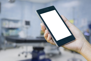 Women ’s Hand holding smart phone with online device on screen over blur Medical Stethoscope Resting on Desk,emergency call concept