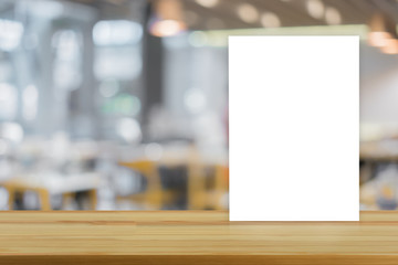 Mock up Menu frame on Table in Bar restaurant cafe,Stand for booklets with white sheets of paper acrylic table tent card mockup on wooden table on cafe teria ,can be used for montage or display