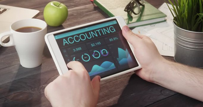 Monitoring accounting data using tablet computer at desk