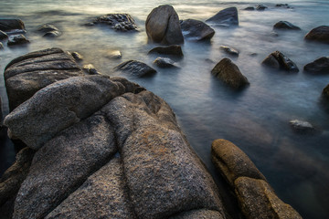 The silky smooth waves and rocks at Lan Hin Khao Beach, Rayong, Thailand.