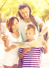  couple with son looking  the map