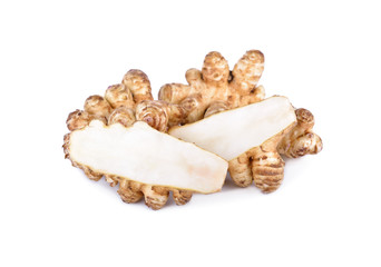 whole and cut fresh Jerusalem Artichoke on white background