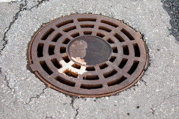 Rusty manhole on a parking