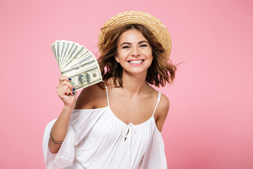 Portrait of a cheerful smiling girl in summer hat