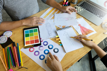young fashion designer work on the table with tailor tool