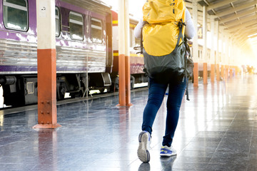 woman with her backpack walking in train station