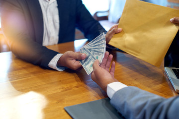 Business man give bribe to the officer