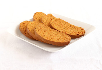 Rusk, a popular, crunchy and crispy biscuit, on a plate.