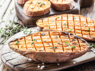 Baked batata on the old wooden table.