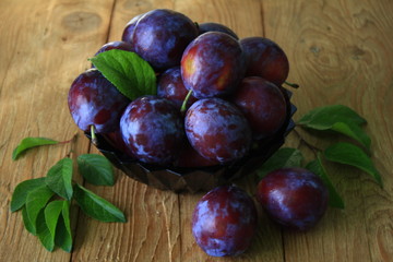 Plums.large ripe plums on wooden table