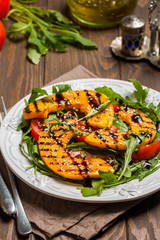 Delicious grilled pumpkin and arugula  salad 
