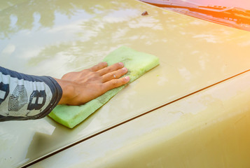 Young men were water stains after wiping the car wash finish.