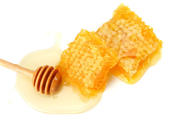 Honeycomb with honey dipper and honey isolated on white background