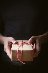 Hands holding a small gift